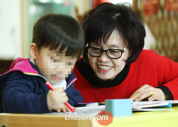 정순희(오른쪽)씨가 1일 서울 양천구 신월동‘서울 SOS 어린이마을’에서 색칠 놀이를 하는 남자 어린이를 돌보고 있다. 