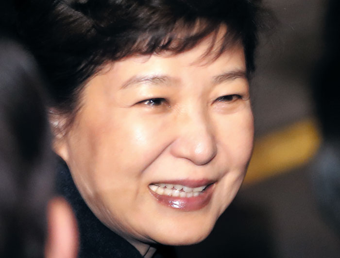 박근혜 전 대통령이 12일 오후 청와대를 떠나 삼성동 사저에 도착한 뒤, 친박 의원 등 지지자들과 인사하며 눈물을 글썽인 채 웃고 있다. 