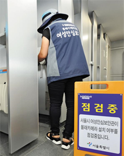 서울시 여성 안심 보안관이 여자 화장실 앞에 ‘점검중’ 푯말을 세우고 몰카가 있는지 탐지하고 있다. 이들은 전자파·적외선 탐지기로 화장실 곳곳을 점검한다.