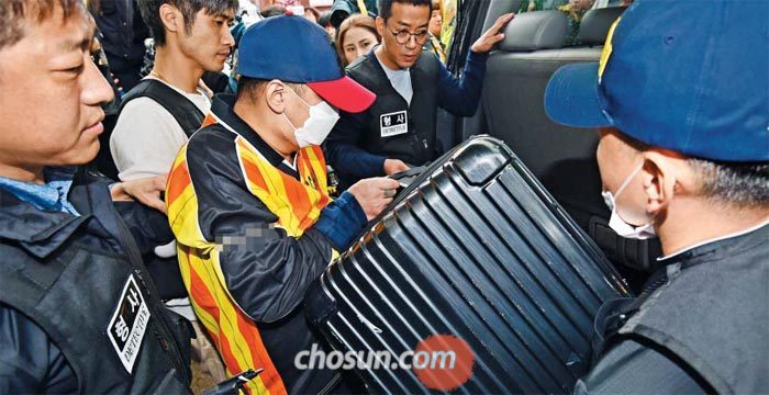 중학생 딸 친구를 살해·유기한 혐의로 구속된 이영학이 11일 오전 현장검증에서 피해 여중생 김양(14)의 시신을 담은 여행용 가방을 차량에 싣는 상황을 재연하고 있다. 이 장면을 지켜보던 일부 주민은 “얼굴을 공개해라” “천하의 나쁜 놈”이라고 소리쳤다.
