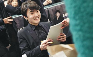 공연 후 팬들에 둘러싸여 사인을 해주는 조성진.