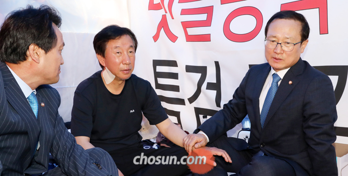 김성태 손잡은 與 새 원내대표 홍영표 - 더불어민주당 홍영표(오른쪽) 원내대표가 11일 신임 원내대표로 선출된 직후 국회 본관 앞에서 ‘드루킹 사건’ 특검을 요구하며 단식농성 중인 자유한국당 김성태(가운데) 원내대표를 찾아가 이야기를 나누고 있다. 왼쪽은 민주당 안민석 의원.