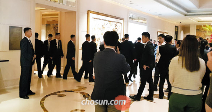 김정은 투숙 호텔 지키는 경호원들 - 11일 오후(현지 시각) 김정은 북한 국무위원장의 싱가포르 숙소인 세인트레지스 호텔에서 북한 경호원들(양복 입은 사람들)이 1층에 도착한 승강기에서 내리고 있다. 김정은은 이 호텔 20층 VIP룸에 묵고 있는 것으로 알려졌다. 