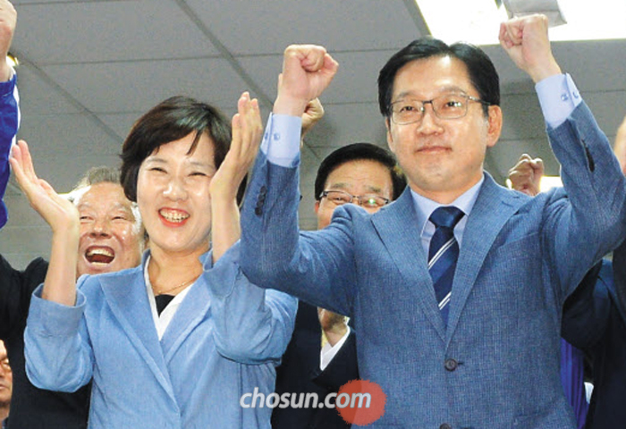 더불어민주당 김경수 경남지사 후보가 13일 경남 창원시 선거캠프에서 출구조사 결과 자신이 우세한 것으로 나타나자 아내 김정순씨와 환호하고 있다.