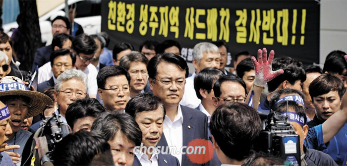 26일 사드 배치 예정지인 경북 성주를 방문한 정진석(가운데) 원내대표 등 새누리당 원내 지도부 인사들이 주민들의 항의를 받으며 굳은 표정으로 성주군청에 들어가고 있다.