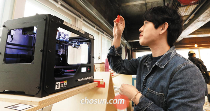 서울 세운상가 ‘팹랩 서울’에서 시각장애인용 점자 스마트워치 개발 스타트업 ‘닷’의 조재윤씨가 3D 프린터로 만든 부품을 살펴보고 있다.