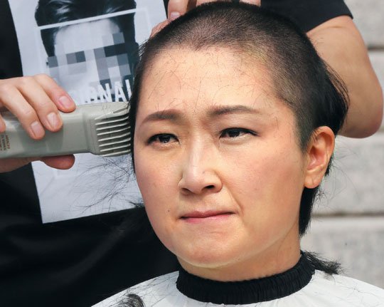 무소속 이언주 의원이 10일 오전 국회 본청 앞 계단에서 조국 법무부 장관 임명에 항의하는 의미로 삭발하고 있다.