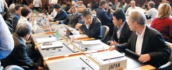 지난 7월 24일 스위스 제네바에 있는 WTO 본부 회의장에서 열린 일반이사회를 앞두고 일본 대표단이 이야기를 나누고 있다. 바로 옆에 한국 대표단이 앉아 있다. /로이터 연합뉴스