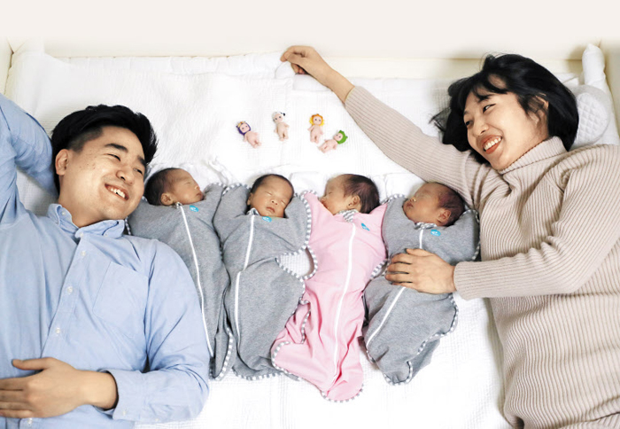 경기도 부천시에 사는 이한솔(31)·나혜승(31)씨 부부가 작년 12월 22일 네쌍둥이를 낳았다. 자연 임신으로 낳은 사란성(四卵性) 쌍둥이 태명은 봄·여름·가을·겨울. 아빠가 총각 시절 아이 넷을 낳겠다며 지은 태명인데 현실이 됐다. 그래서 이씨 별명은 ‘춘하추동 아빠’다. 지난 19일 여섯 식구가 사는 아파트 안방에서 아빠(사진 맨 왼쪽)와 엄마가 네쌍둥이를 바라보며 환하게 웃고 있다. 아빠 옆에 태어난 순서대로 누워 있는 봄(하온)·여름(하민)·가을(하음)·겨울(하준) 머리맡에는 아빠 친구가 선물한 인형 네 개가 놓여 있다.