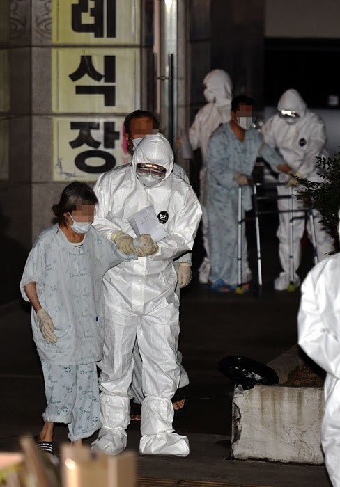 확진자들이 대거 발생한 제2미주병원에서 이송되는 환자들이 27일 오후 병원에서 나오고 있다./뉴시스