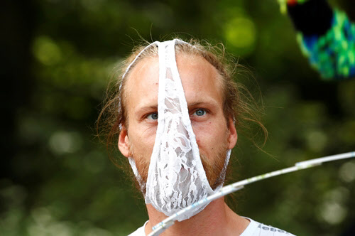 A man with feminine panties on his face.  It seems to be an indication that you don't want to wear a mask. / Reuters Yonhap News