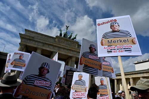 Poster mocking and criticizing Prime Minister Angela Merkel and ministers / AFP Yonhap News