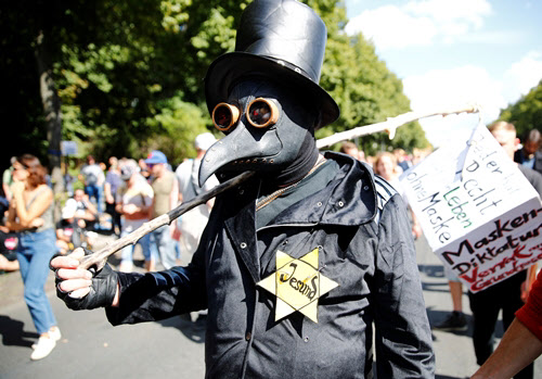 One of the protesters dressed up as an infectious disease healer and took part in the protests./Reuters Yonhap News