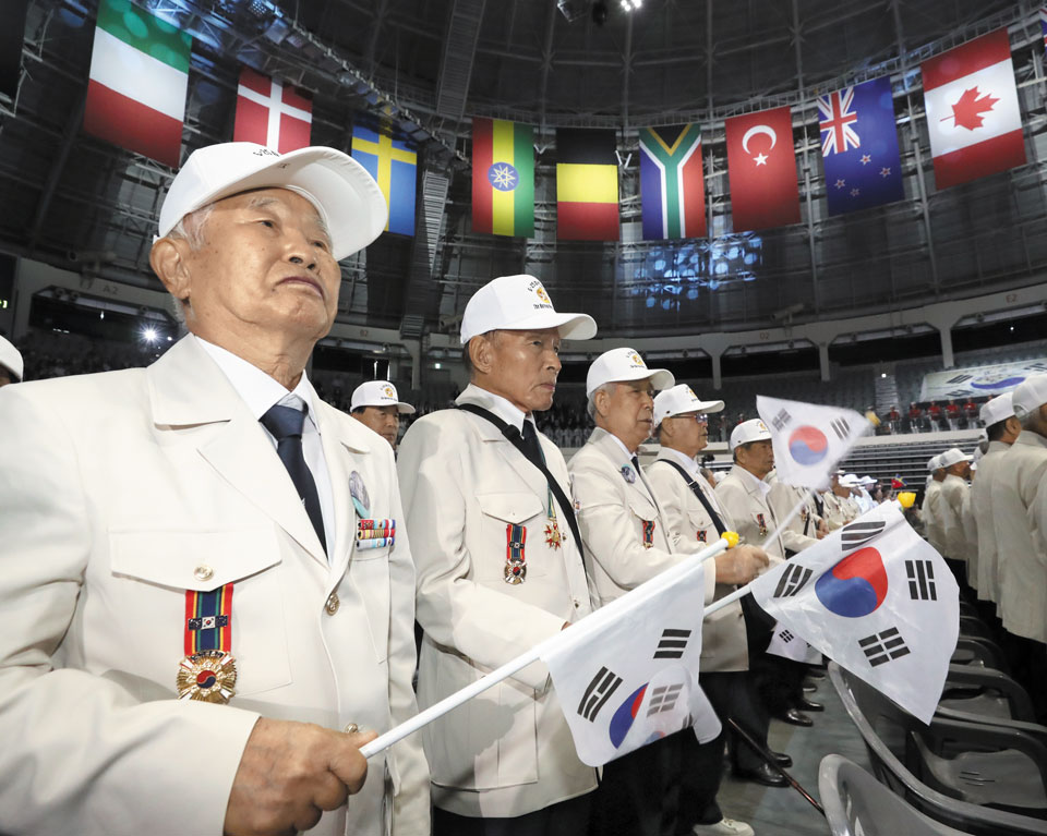 '6·25의 노래' 부르는 참전 유공자들 - 6·25 전쟁 참전 유공자들이 25일 서울 중구 장충체육관에서 열린 6·25 전쟁 73주년 행사에서 태극기를 흔들며 '6·25의 노래'를 부르고 있다. 이들이 입은 옷은 국가보훈부가 정전 70주년을 계기로 새로 만들어 참전 용사들에게 무상으로 지급한 '영웅의 제복'이다. /오종찬 기자